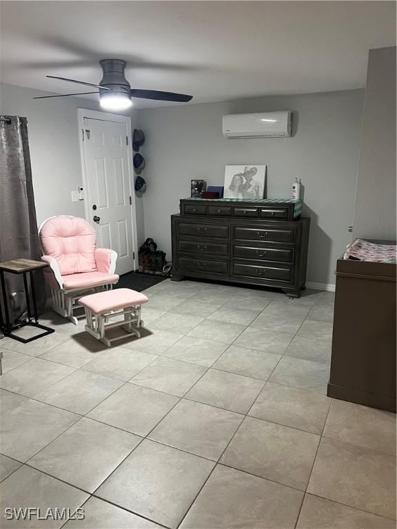 sitting room with a wall mounted air conditioner, ceiling fan, and light tile patterned floors