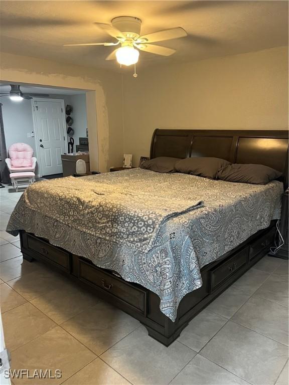 bedroom featuring ceiling fan and light tile patterned flooring