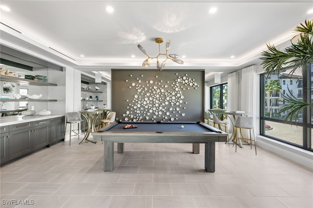 rec room with pool table, a raised ceiling, and recessed lighting