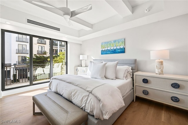 bedroom featuring ceiling fan, wood finished floors, visible vents, access to exterior, and beam ceiling