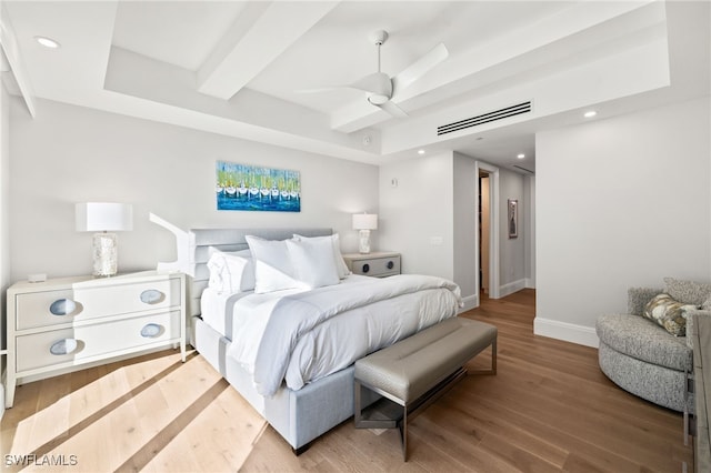 bedroom with recessed lighting, wood finished floors, visible vents, baseboards, and beamed ceiling