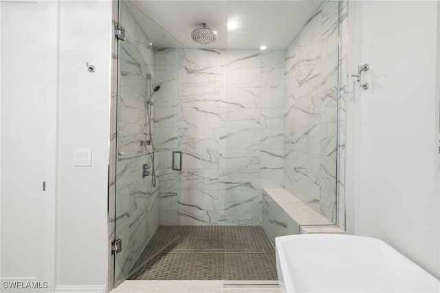 bathroom featuring a marble finish shower