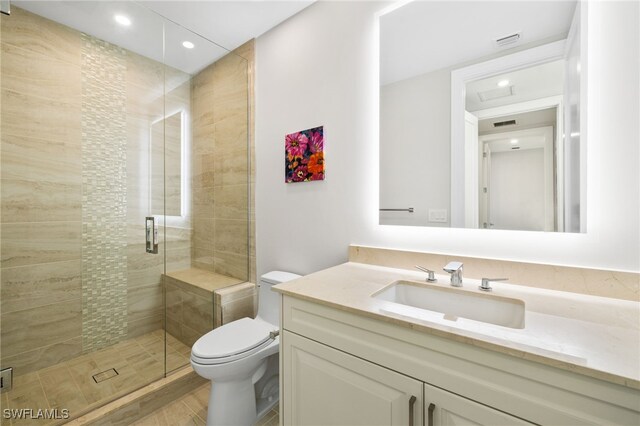 bathroom featuring a stall shower, vanity, toilet, and recessed lighting