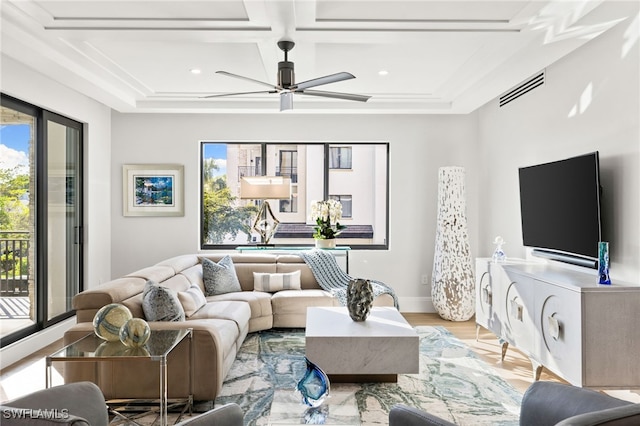 living area with light wood finished floors, baseboards, visible vents, coffered ceiling, and a ceiling fan