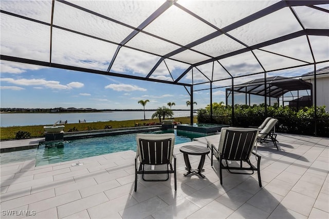 view of swimming pool with glass enclosure, a patio area, a water view, and an in ground hot tub