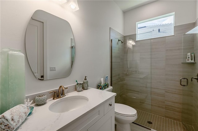 bathroom featuring vanity, toilet, and walk in shower