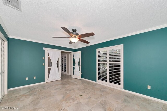 unfurnished room with french doors, a textured ceiling, ceiling fan, and crown molding