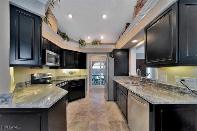 kitchen featuring kitchen peninsula, light stone countertops, sink, and appliances with stainless steel finishes