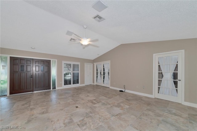 unfurnished living room with a textured ceiling, ceiling fan, and vaulted ceiling