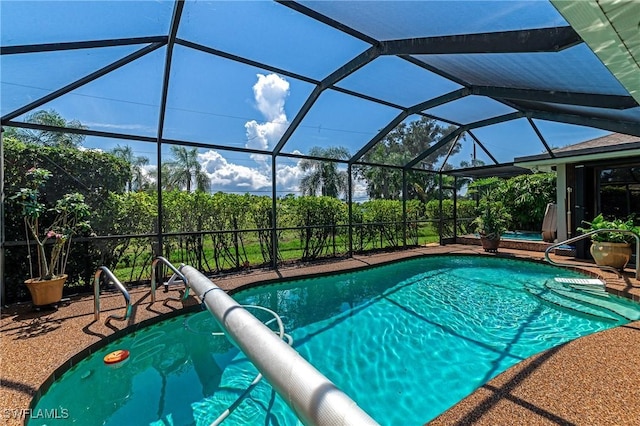 view of swimming pool featuring glass enclosure