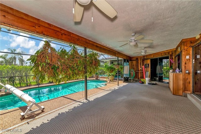 view of pool featuring ceiling fan, a lanai, and a patio