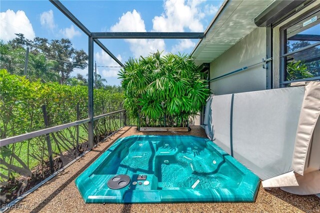 view of swimming pool featuring a lanai