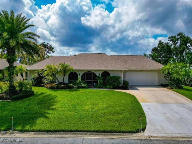 ranch-style house with a garage and a front lawn