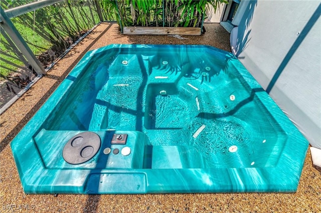 view of swimming pool with an indoor hot tub