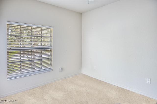 carpeted spare room with baseboards