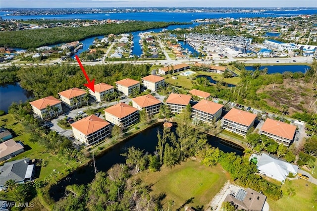 drone / aerial view featuring a residential view and a water view