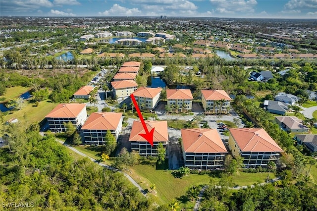 birds eye view of property featuring a water view and a residential view