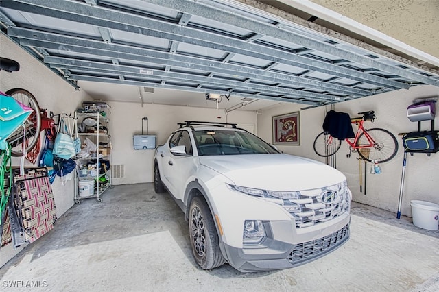 garage with visible vents and a garage door opener