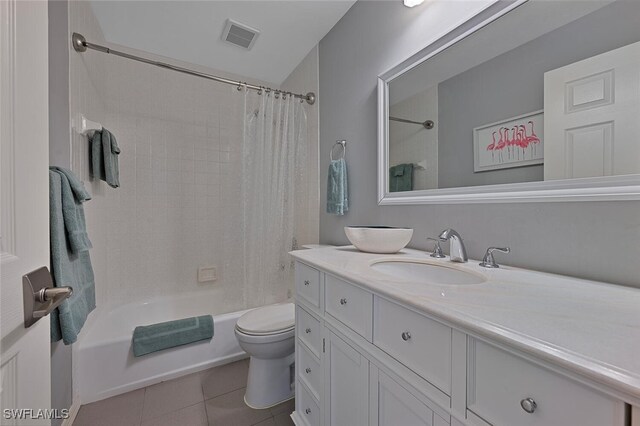 full bathroom featuring vanity, toilet, tile patterned flooring, and shower / bath combo