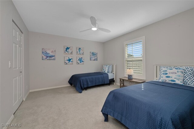 bedroom featuring a closet, ceiling fan, and carpet