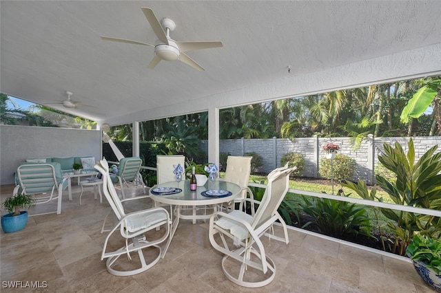 sunroom / solarium featuring ceiling fan and vaulted ceiling