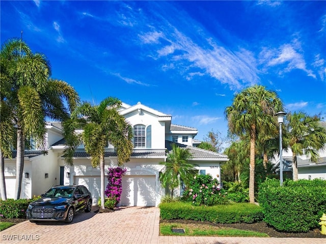 mediterranean / spanish house featuring a garage