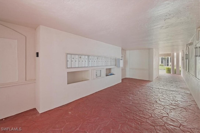 11921 Seabreeze Cove Ln Unit 202, Fort Myers, FL 33908 - hallway with mail area and a textured ceiling
