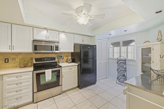 11921 Seabreeze Cove Ln Unit 202, Fort Myers, FL 33908 - kitchen with appliances with stainless steel finishes, ceiling fan, tasteful backsplash, light countertops, and light tile patterned flooring