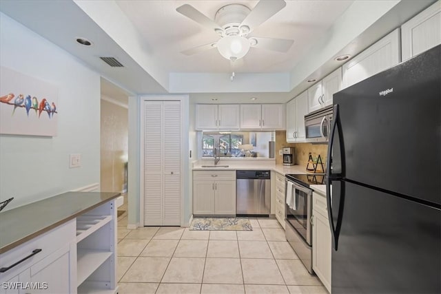 11921 Seabreeze Cove Ln Unit 202, Fort Myers, FL 33908 - kitchen with appliances with stainless steel finishes, white cabinetry, a ceiling fan, light tile patterned flooring, and open shelves