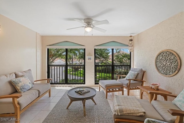 11921 Seabreeze Cove Ln Unit 202, Fort Myers, FL 33908 - living area featuring a textured wall, light tile patterned floors, and ceiling fan