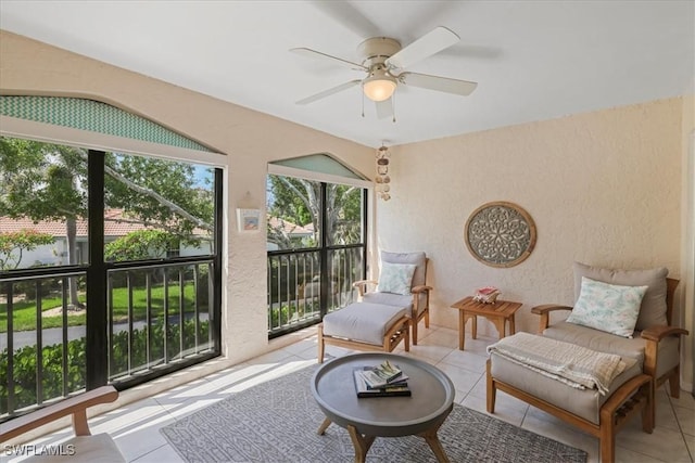 11921 Seabreeze Cove Ln Unit 202, Fort Myers, FL 33908 - living area with tile patterned flooring, ceiling fan, and a textured wall