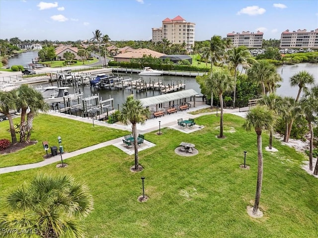 11921 Seabreeze Cove Ln Unit 202, Fort Myers, FL 33908 - view of property's community with a lawn, a water view, a boat dock, and boat lift