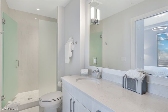 bathroom with vanity, toilet, and a shower with shower door