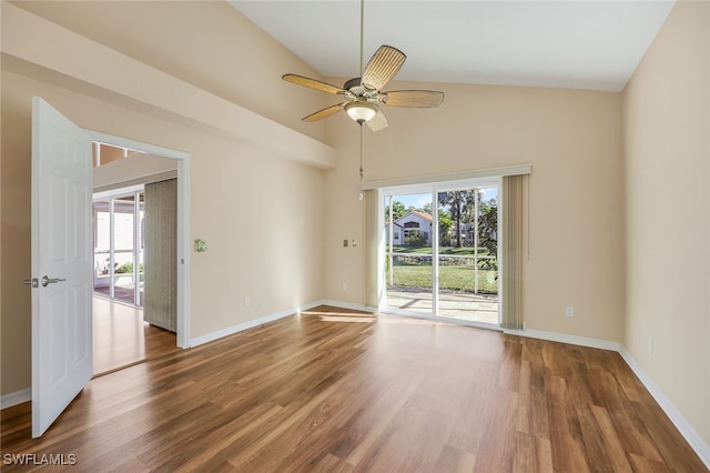 empty room with ceiling fan, hardwood / wood-style floors, a healthy amount of sunlight, and lofted ceiling