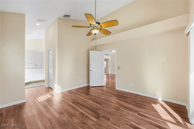 spare room with ceiling fan, wood-type flooring, and vaulted ceiling