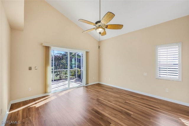 spare room with ceiling fan, hardwood / wood-style floors, high vaulted ceiling, and a healthy amount of sunlight