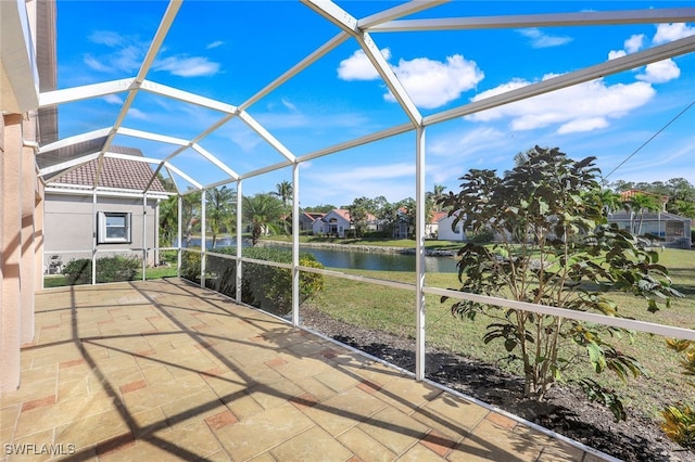 unfurnished sunroom with a water view, lofted ceiling, and a pool