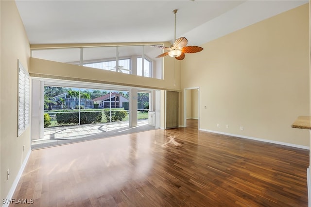 unfurnished living room featuring hardwood / wood-style floors, high vaulted ceiling, and ceiling fan