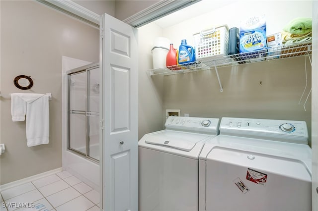 laundry area with separate washer and dryer and light tile patterned floors