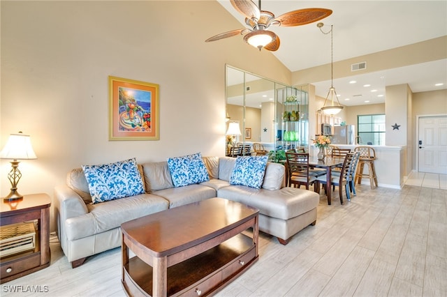 living room featuring light wood-type flooring, ceiling fan, and lofted ceiling