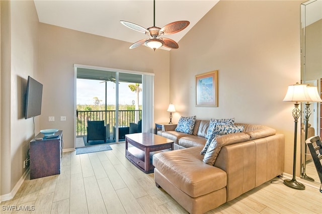 living room featuring ceiling fan, vaulted ceiling, and light hardwood / wood-style flooring