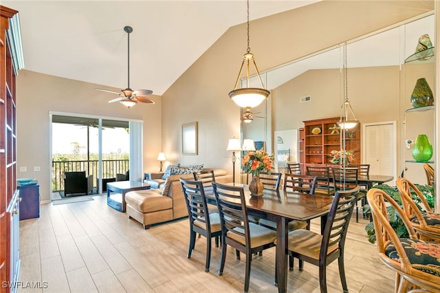 dining area featuring light hardwood / wood-style floors, high vaulted ceiling, and ceiling fan