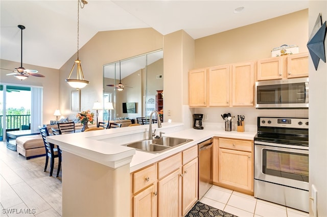 kitchen with kitchen peninsula, sink, light brown cabinets, and appliances with stainless steel finishes