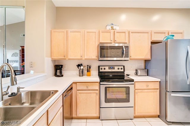 kitchen featuring decorative backsplash, light brown cabinetry, stainless steel appliances, and sink