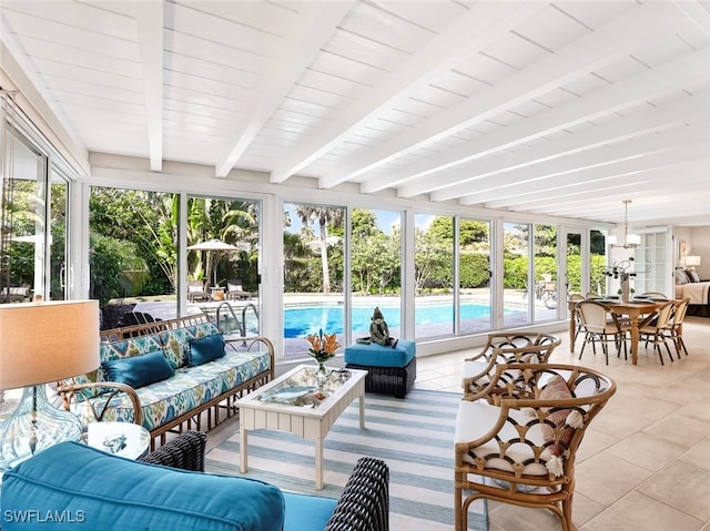 sunroom / solarium featuring beam ceiling