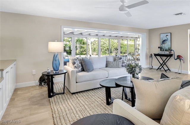 living room featuring a wealth of natural light and ceiling fan