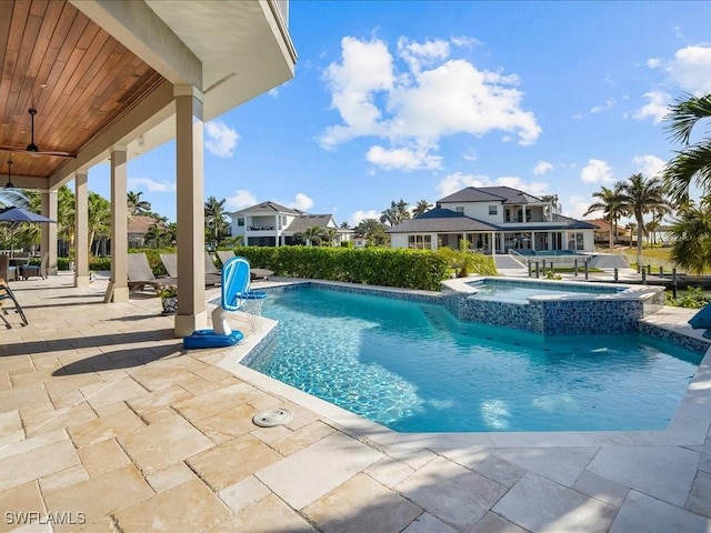 view of pool featuring a patio area, an in ground hot tub, and ceiling fan