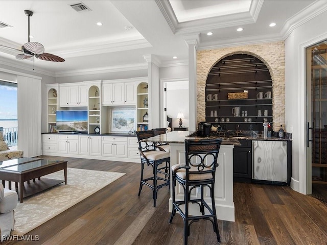 bar with white cabinetry, crown molding, dark hardwood / wood-style flooring, and ceiling fan