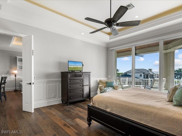 bedroom with ceiling fan, access to exterior, crown molding, and a tray ceiling