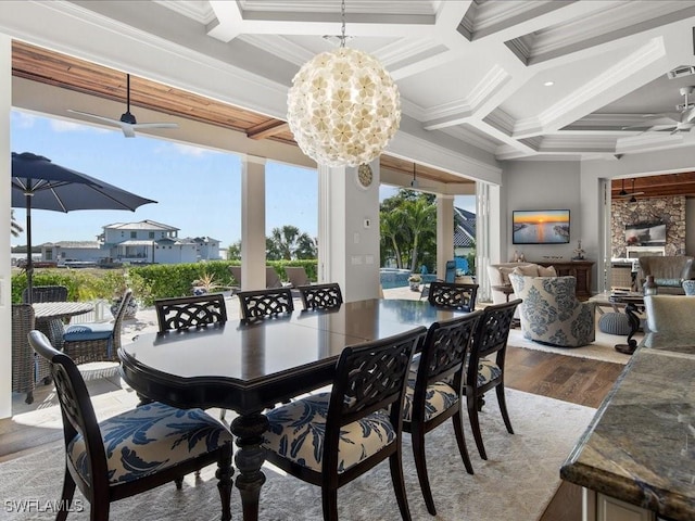 dining room with ornamental molding, coffered ceiling, ceiling fan with notable chandelier, beam ceiling, and hardwood / wood-style flooring